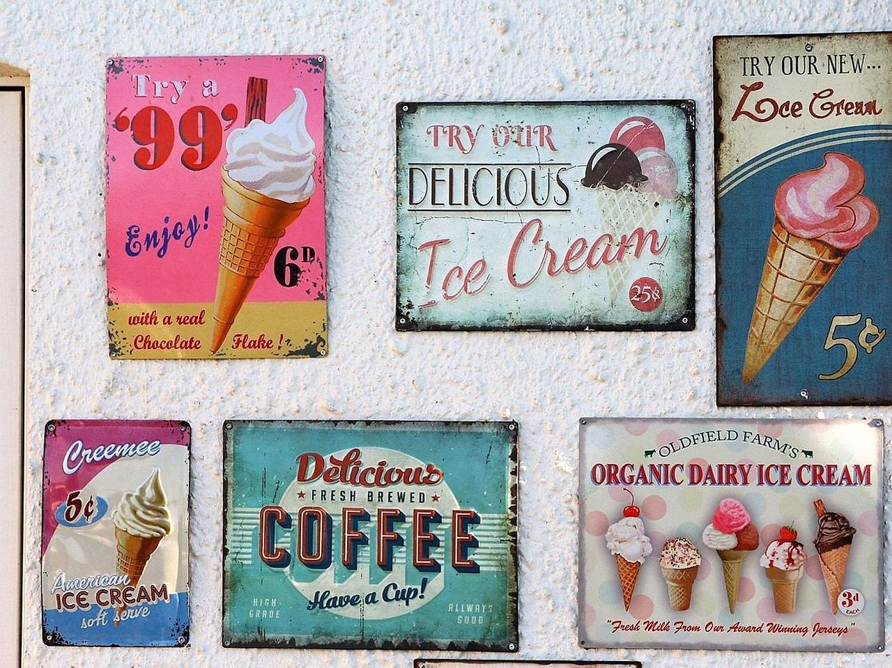 Vintage poster art pinned against whitewashed studio wall